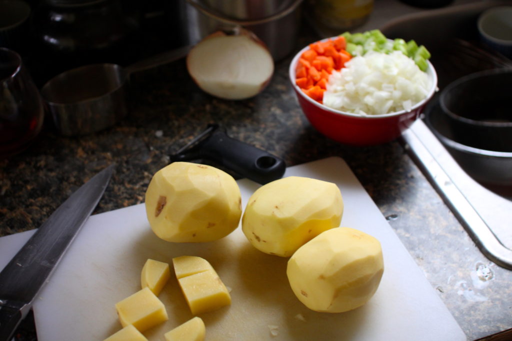 Photo of potatoes and mirepoix being prepped