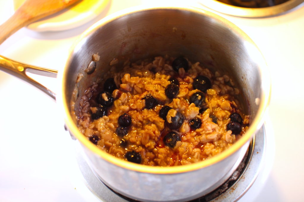 Blueberry muffin oatmeal cooking in a pot